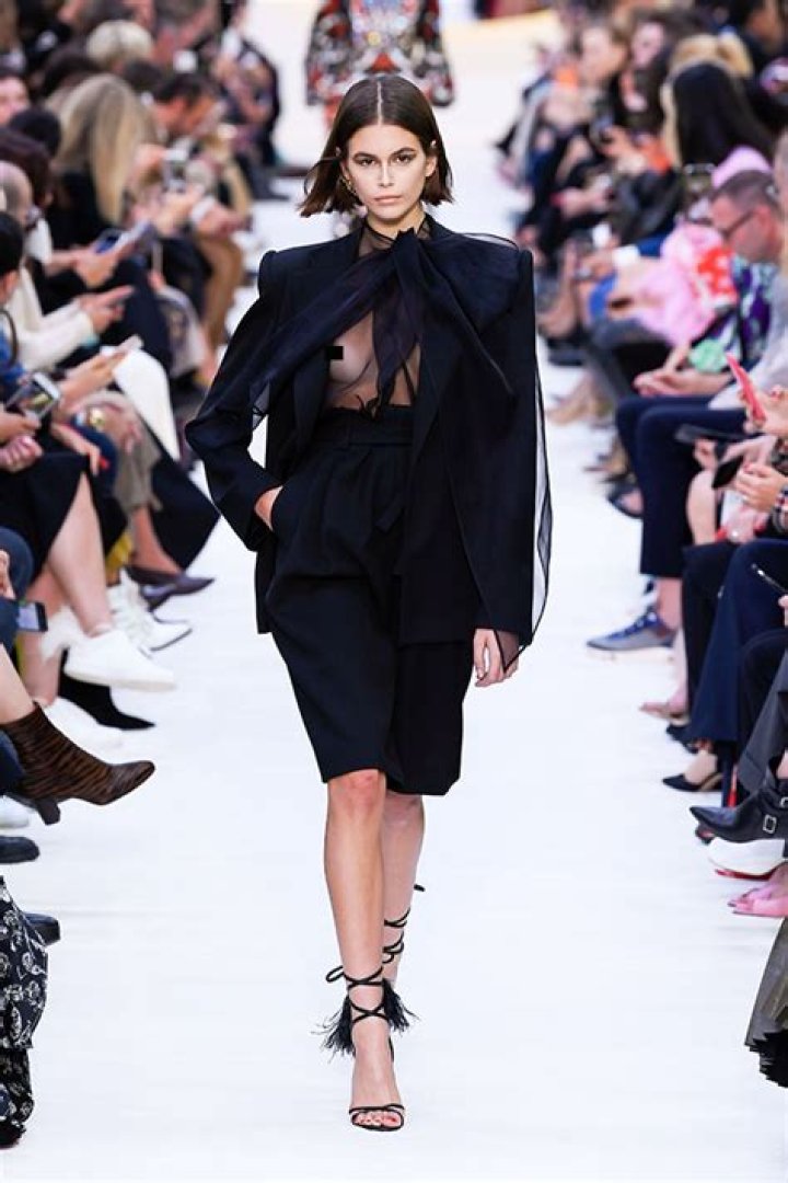 Kaia Gerber Confidently Walks Valentino Runway In Sheer Black Bow Blouse